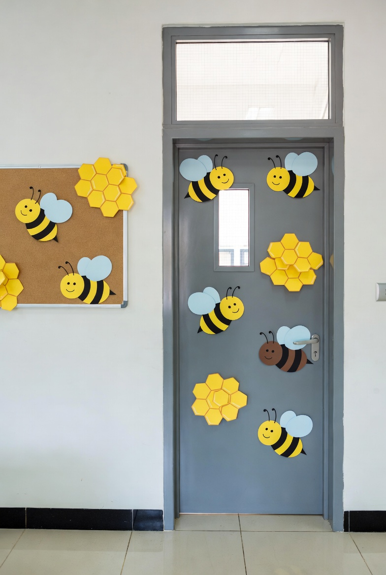 classroom door decorated with paper bees and honeycomb