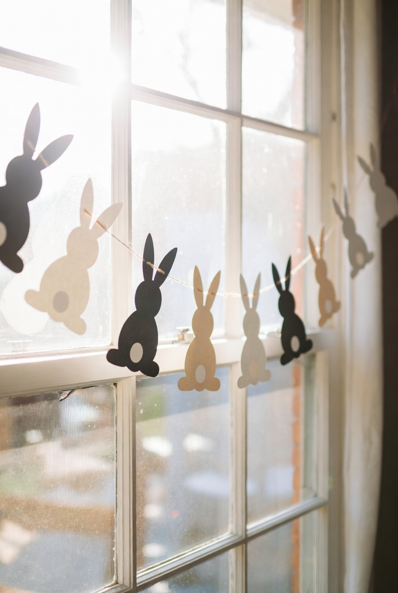 DIY paper bunny garland decorating a window for Easter