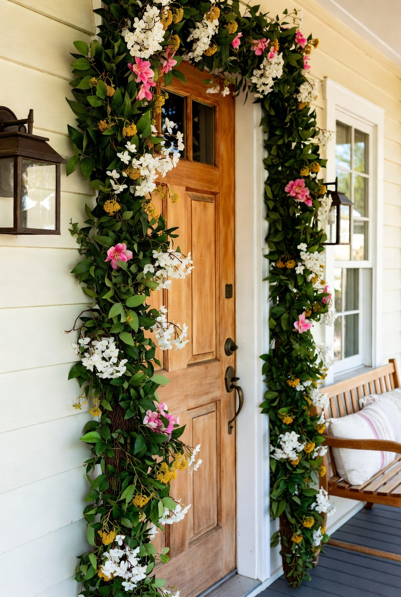 Spring floral garland decorating small porch door frame