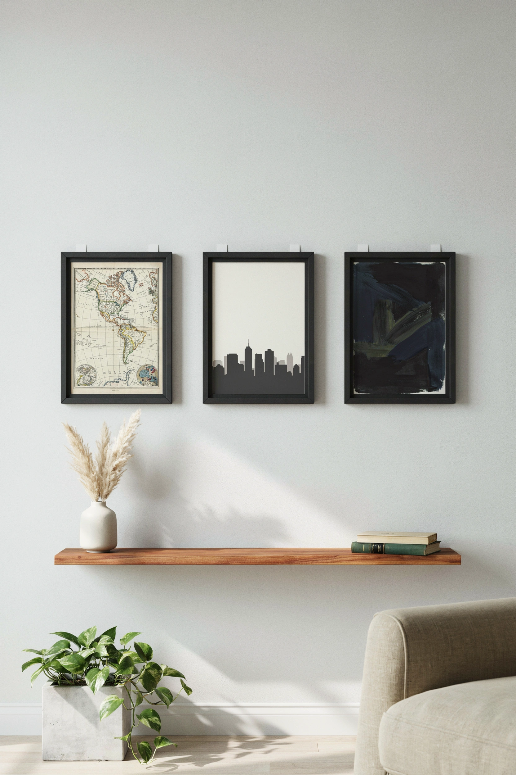 Masculine gallery wall with black frames and vintage map prints — college bedroom wall decor ideas for men