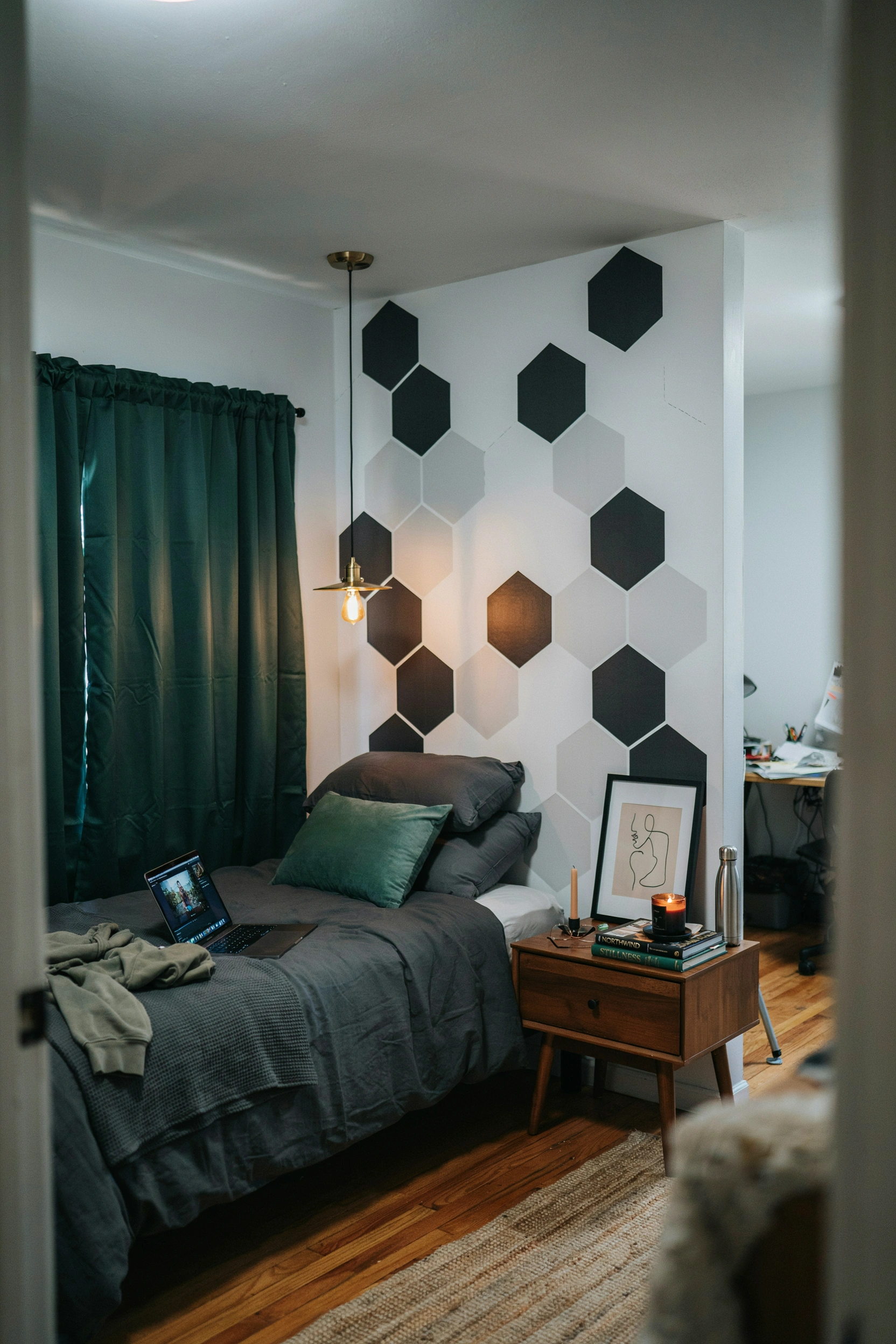 Dark, moody college dorm room for men without painting — peel-and-stick wallpaper, dark bedding, warm amber lighting